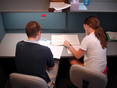 Tutor helps student with physics homework. PHOTO BY ROGER WINSTEAD